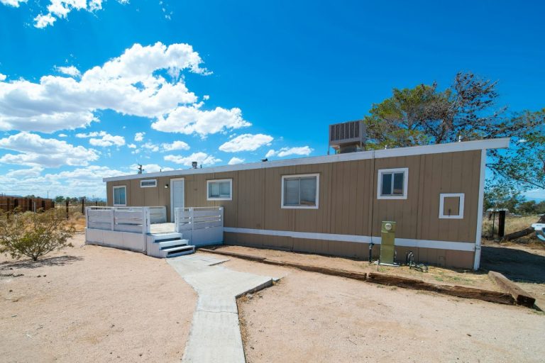 A well-kept mobile home in a sunny neighborhood, showing affordable and flexible living options.
